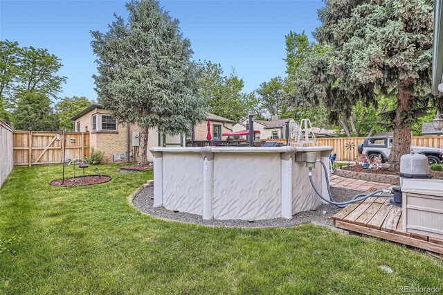 5704 Ammons St, Arvada, CO 80002 - view of yard featuring a wooden deck and an outdoor pool
