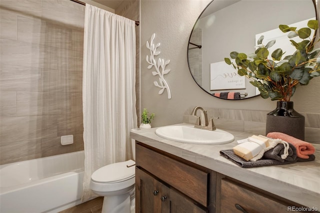 full bathroom featuring shower / tub combo with curtain, vanity with extensive cabinet space, and toilet