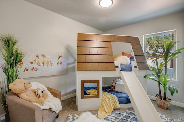 sitting room featuring carpet and lofted ceiling