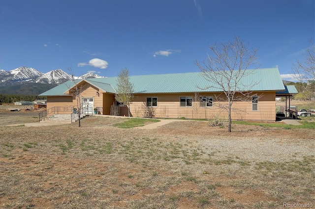 single story home with a mountain view and metal roof