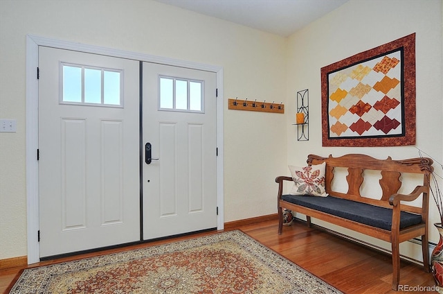 entrance foyer with baseboards and wood finished floors