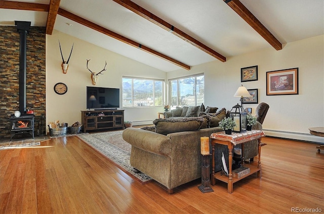 living room featuring a baseboard radiator, a baseboard heating unit, wood finished floors, beamed ceiling, and a wood stove