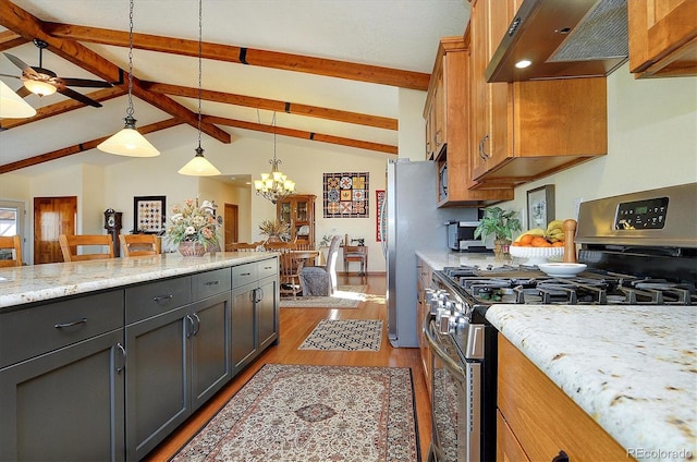 kitchen featuring lofted ceiling with beams, light stone counters, light wood-style flooring, under cabinet range hood, and appliances with stainless steel finishes