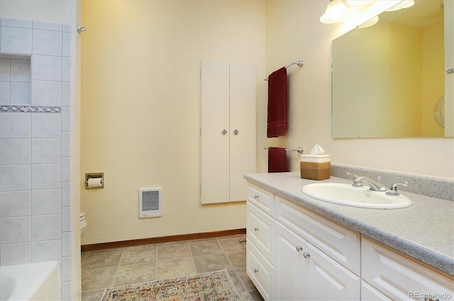 bathroom featuring visible vents, vanity, and baseboards