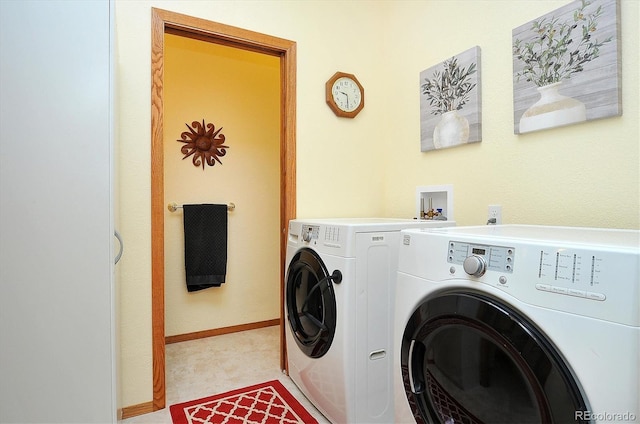 laundry room featuring laundry area, baseboards, and separate washer and dryer