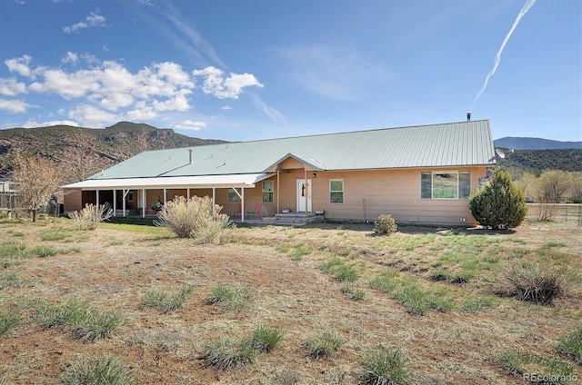 view of front of home featuring metal roof and a mountain view