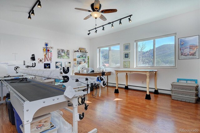 42 Holiday Hills Blvd, Howard, CO 81233 - interior space with track lighting, wood finished floors, ceiling fan, and a baseboard heating unit