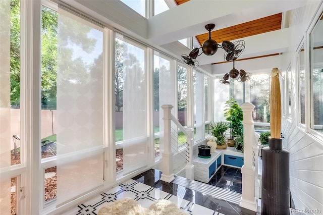 sunroom / solarium featuring an inviting chandelier