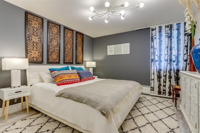 bedroom with a baseboard heating unit and a notable chandelier