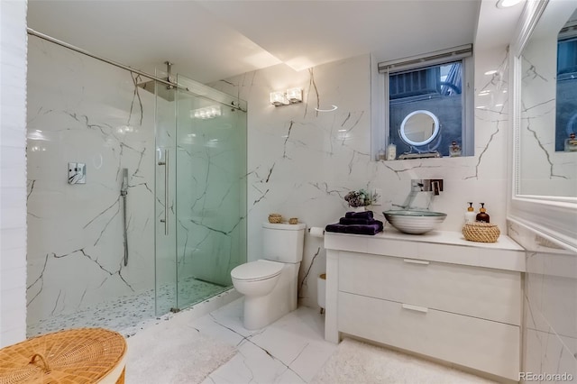 bathroom with vanity, toilet, and a shower with shower door