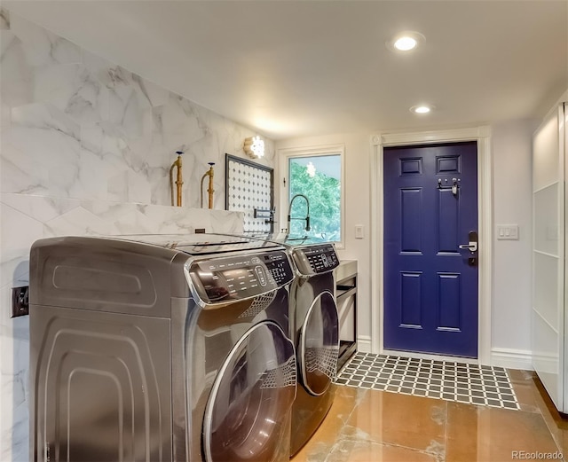 laundry area featuring washer and dryer and tile patterned flooring