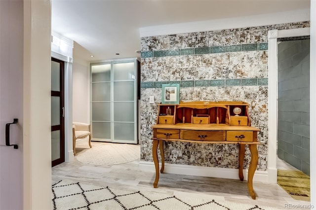 misc room featuring light hardwood / wood-style flooring and ornamental molding