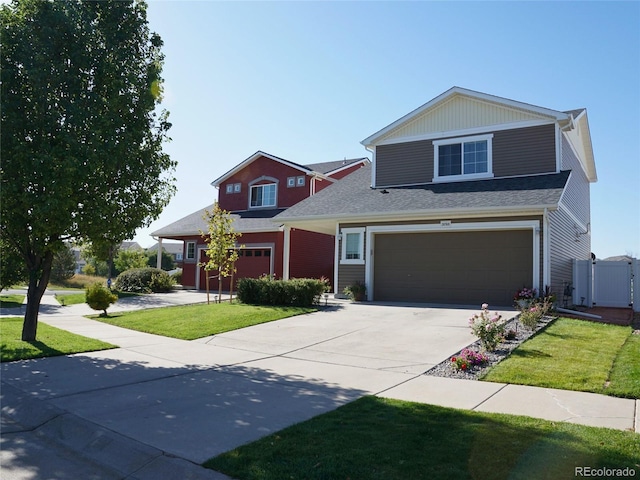 view of front of home with fence, a garage, a front lawn, and driveway