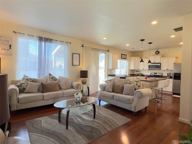 living room featuring recessed lighting, visible vents, and dark wood finished floors
