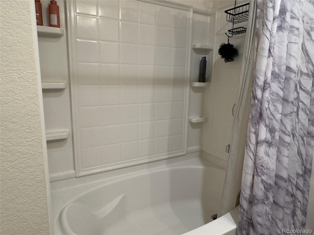 full bathroom featuring a textured wall