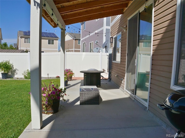 view of patio / terrace with fence and a residential view