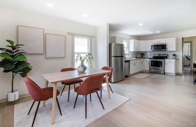 dining room featuring recessed lighting and light wood-style floors