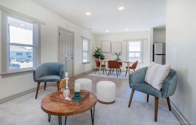 living room featuring plenty of natural light, recessed lighting, and baseboards