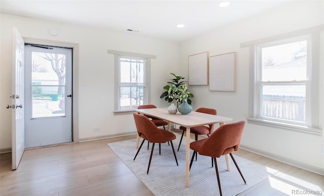 dining space with light wood-style floors, baseboards, recessed lighting, and visible vents