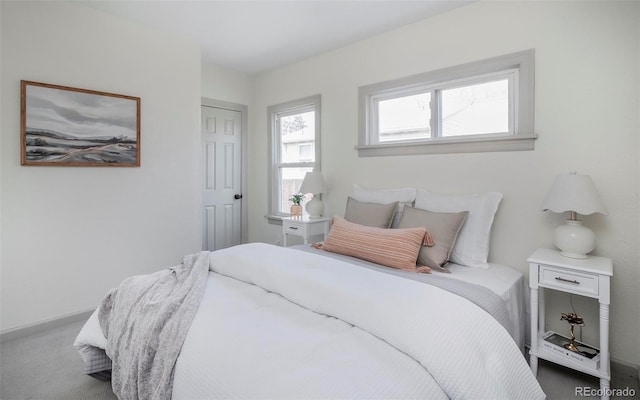 carpeted bedroom featuring baseboards