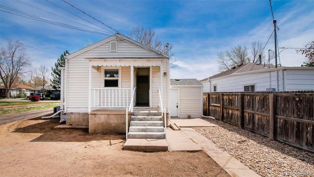 exterior space featuring a porch and fence
