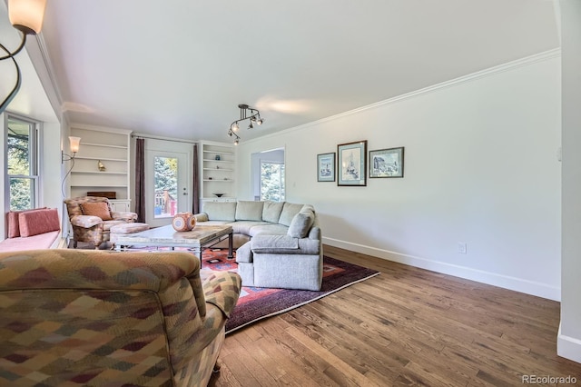6451 Crestbrook Dr, Morrison, CO 80465 - living room featuring wood finished floors, baseboards, crown molding, and built in shelves