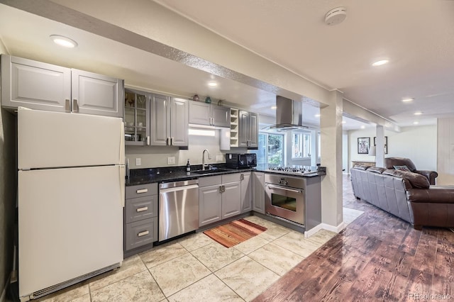 6451 Crestbrook Dr, Morrison, CO 80465 - kitchen featuring appliances with stainless steel finishes, gray cabinetry, island range hood, a sink, and glass insert cabinets