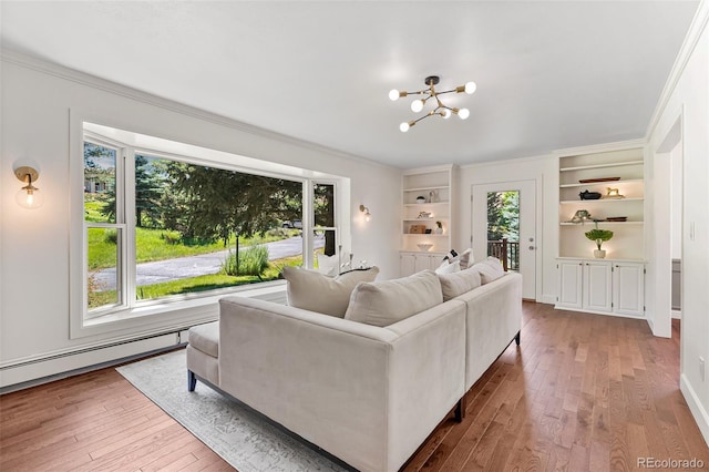 6451 Crestbrook Dr, Morrison, CO 80465 - living room featuring wood-type flooring, a chandelier, built in shelves, and crown molding