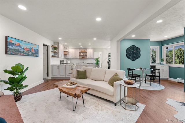 6451 Crestbrook Dr, Morrison, CO 80465 - living area featuring recessed lighting, light wood finished floors, and a baseboard radiator