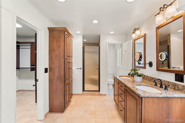 6451 Crestbrook Dr, Morrison, CO 80465 - bathroom featuring double vanity, a stall shower, tile patterned floors, a closet, and ornamental molding