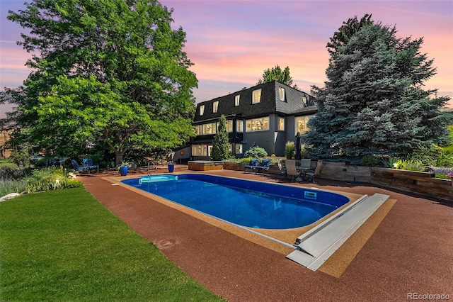 6451 Crestbrook Dr, Morrison, CO 80465 - pool at dusk with an outdoor pool, a yard, and a patio