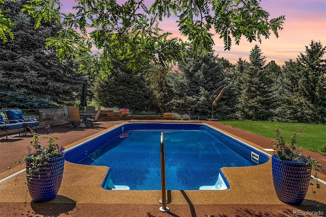 6451 Crestbrook Dr, Morrison, CO 80465 - pool at dusk with a patio area and an outdoor pool