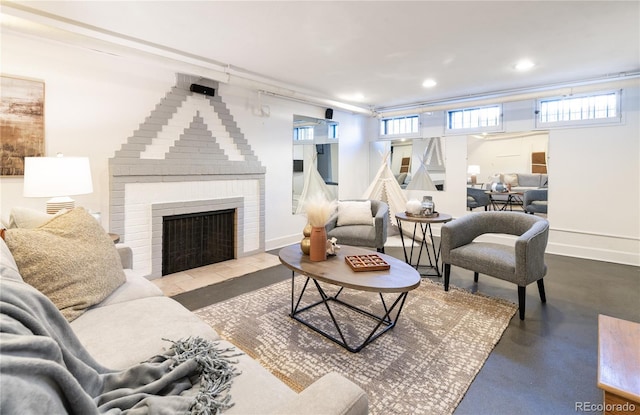 living room with a brick fireplace