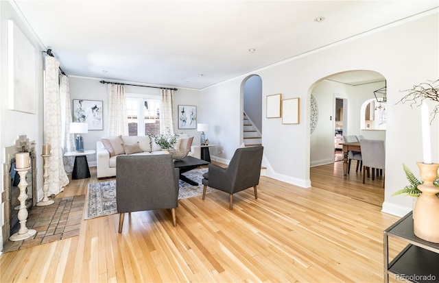 living room with hardwood / wood-style floors and ornamental molding