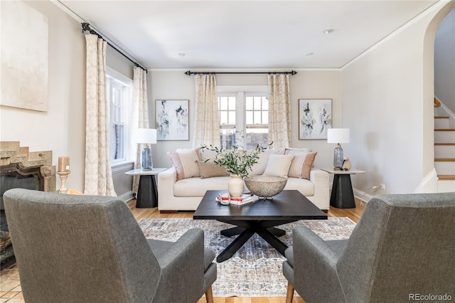 living room featuring light wood-type flooring and ornamental molding