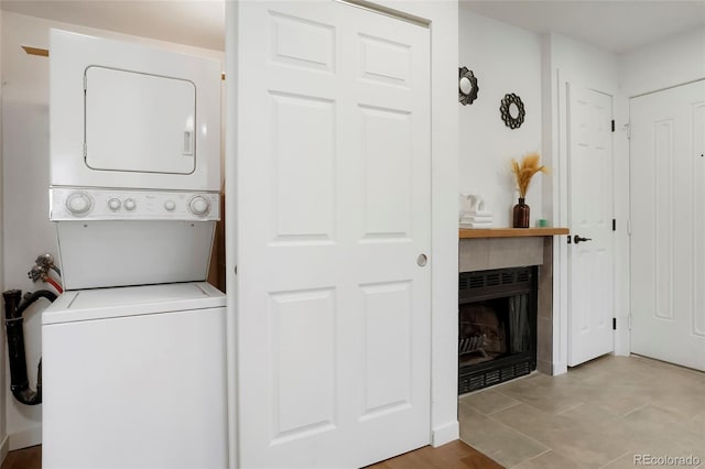 8701 Huron St Unit 2-106, Thornton, CO 80260 - laundry area featuring stacked washer / dryer and a fireplace