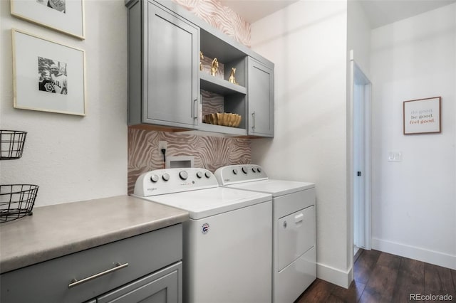 1004 Tree Bark Ter, Colorado Springs, CO 80921 - clothes washing area featuring cabinet space, dark wood finished floors, washing machine and dryer, and baseboards