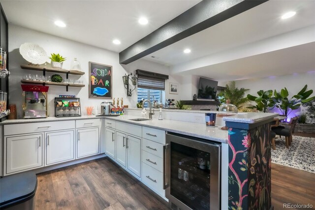 1004 Tree Bark Ter, Colorado Springs, CO 80921 - kitchen with wine cooler, a peninsula, dark wood-style flooring, a sink, and recessed lighting