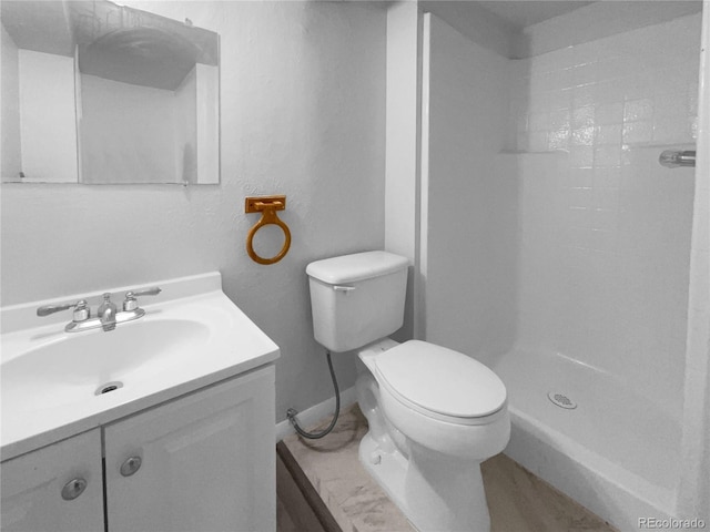 bathroom with vanity, toilet, and walk in shower