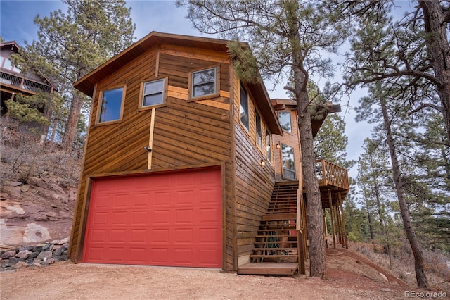 exterior space with a wooden deck and a garage