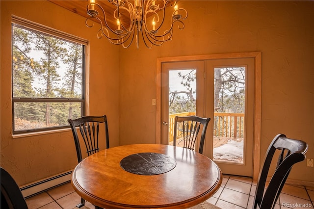 dining area featuring an inviting chandelier, light tile patterned flooring, and baseboard heating