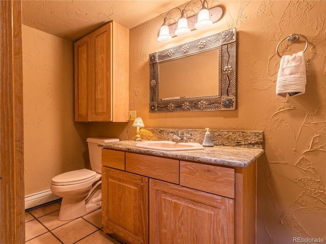 bathroom featuring tile patterned floors, toilet, vanity, and a baseboard heating unit