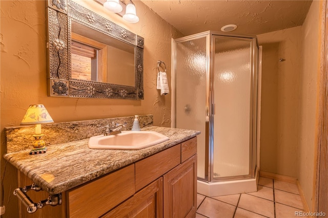 bathroom featuring tile patterned flooring, vanity, and an enclosed shower