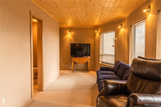 carpeted living room featuring wooden ceiling