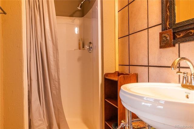 bathroom with walk in shower and sink