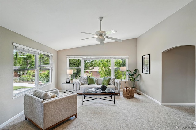 3570 E Arapahoe Pl, Centennial, CO 80122 - carpeted living room featuring vaulted ceiling, arched walkways, ceiling fan, healthy amount of natural light, and baseboards
