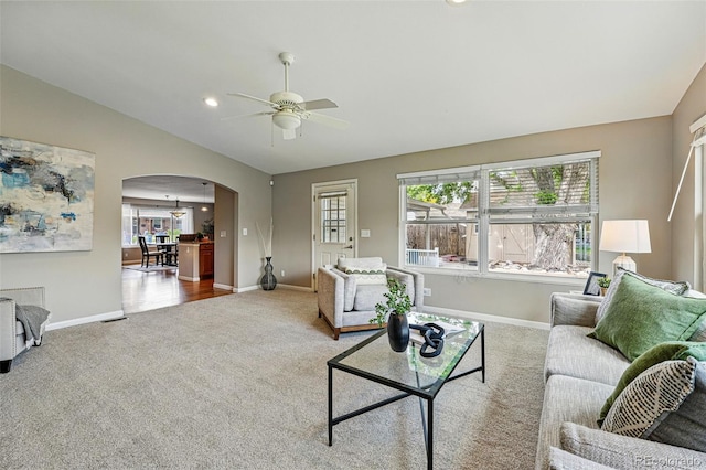 3570 E Arapahoe Pl, Centennial, CO 80122 - carpeted living area with arched walkways, lofted ceiling, baseboards, ceiling fan, and plenty of natural light
