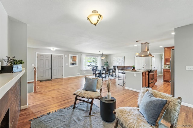 3570 E Arapahoe Pl, Centennial, CO 80122 - living room featuring light wood finished floors, baseboards, and recessed lighting