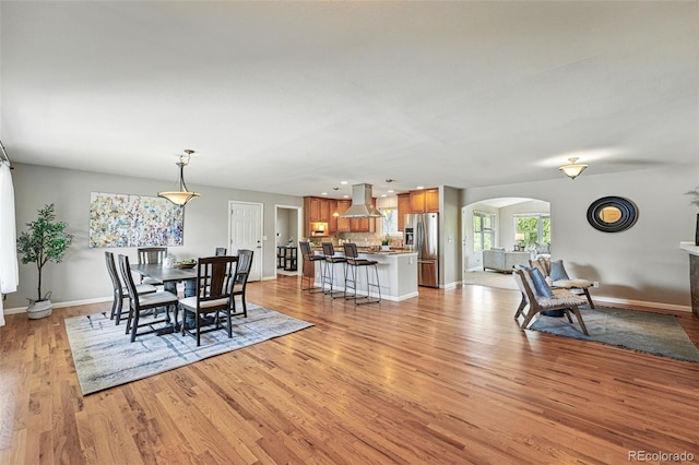 3570 E Arapahoe Pl, Centennial, CO 80122 - dining space featuring arched walkways, light wood finished floors, baseboards, and recessed lighting