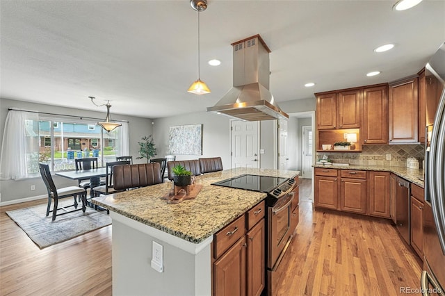 3570 E Arapahoe Pl, Centennial, CO 80122 - kitchen featuring island range hood, appliances with stainless steel finishes, light wood-type flooring, brown cabinetry, and recessed lighting